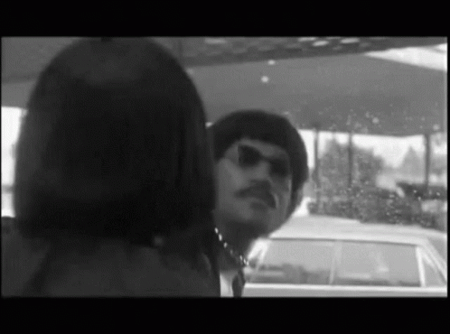 Man with Mustache Looking at Woman in Car