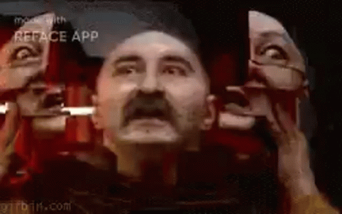 Man with Mustache Looking in Mirror