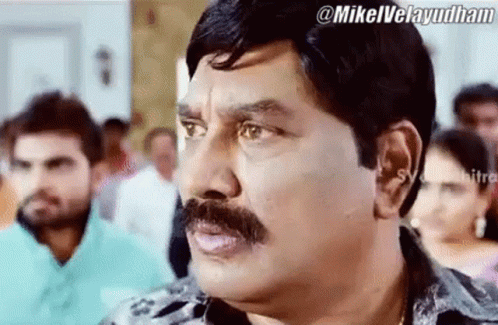 Man With Mustache Making Funny Face In Crowd GIF