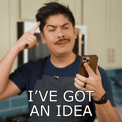 Man with Mustache Pointing at Head Saying Ive Got An Idea