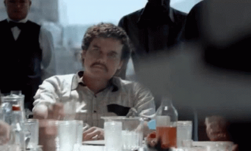 Man with Mustache Sitting at Table