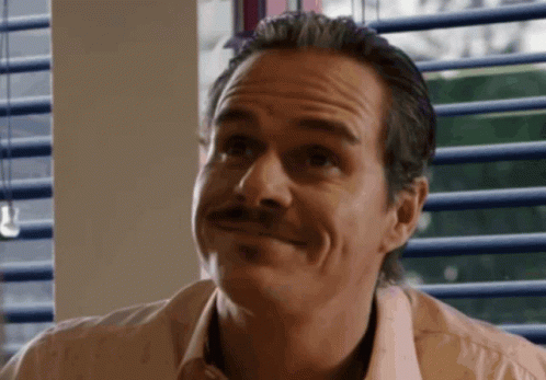 Man With Mustache Smiling at Camera