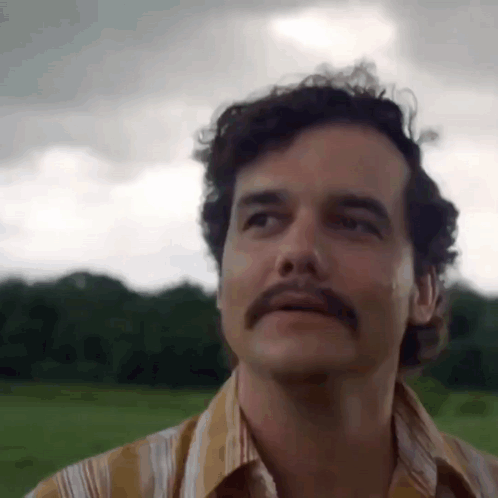 Man with Mustache Standing in Field