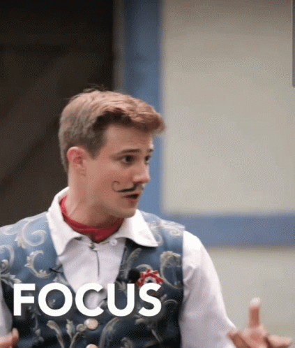 Man With Mustache Standing in Front of Focus