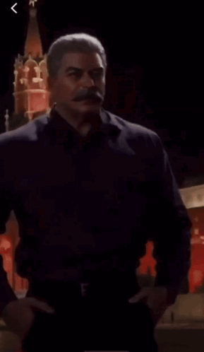 Man with Mustache Standing in Front of Red Tower