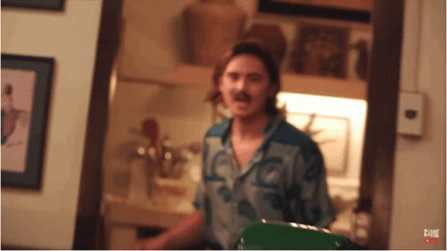Man With Mustache Standing In Room GIF