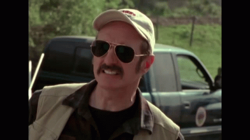 Man with Mustache, Sunglasses, and Hat by Truck