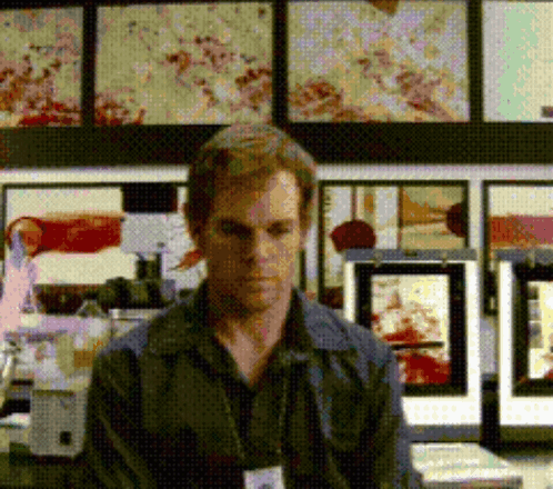Man with Name Tag in Front of Pictures