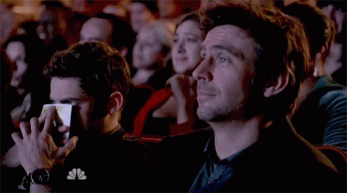 Man with NBC Shirt Watching Show