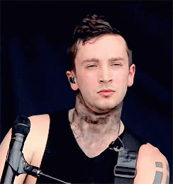 Man with Neck Tattoo and Eyes Closed at Microphone
