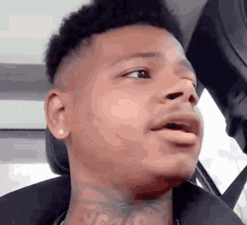 Man With Neck Tattoo Making Funny Face in Car