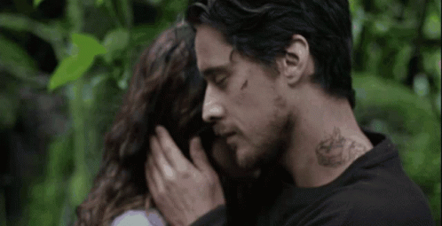 Man With Neck Tattoo Touching Woman's Forehead GIF