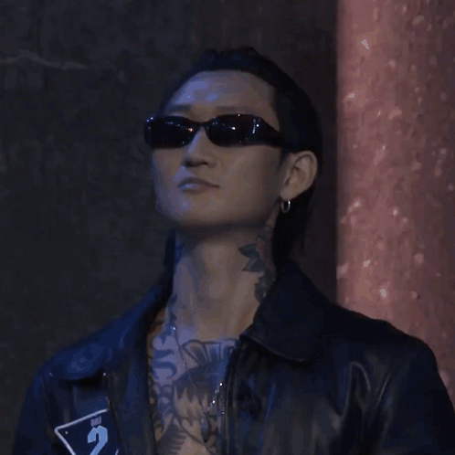 Man with Neck Tattoo Wearing Sunglasses and Leather Jacket