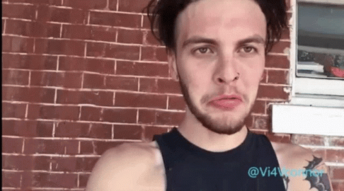Man With Nose Ring At Brick Building GIF