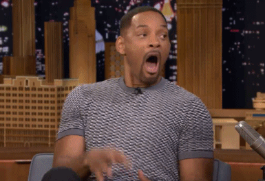 Man With Open Mouth and Hands in Air