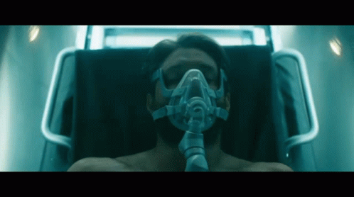 Man With Oxygen Mask Laying in Bed