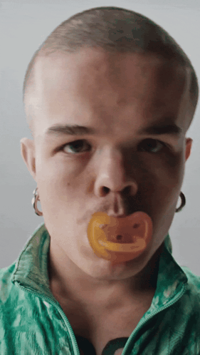 Man With Pacifier In Mouth Looking At Camera GIF
