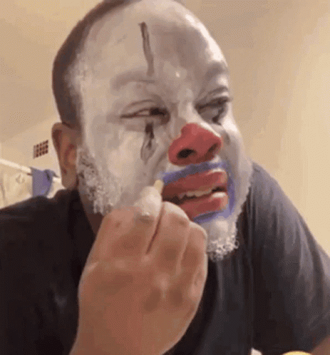 Man With Painted Clown Face Eating