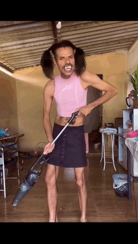 Man with Pigtails Holding Vacuum Cleaner