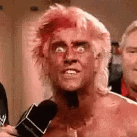 Man with Pink Hair Talking Into Microphone