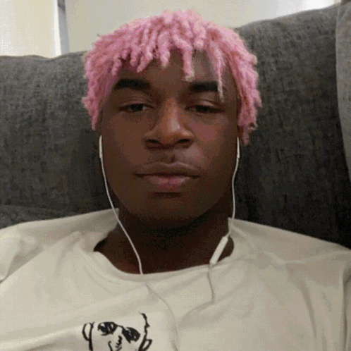 Man With Pink Hair Wearing Headphones and White Shirt With Dog
