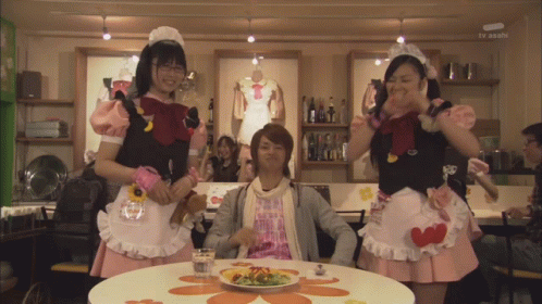Man With Plate of Food and Maids Behind