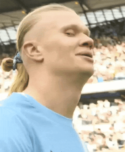 Man With Ponytail And Blue Shirt Looking Up GIF