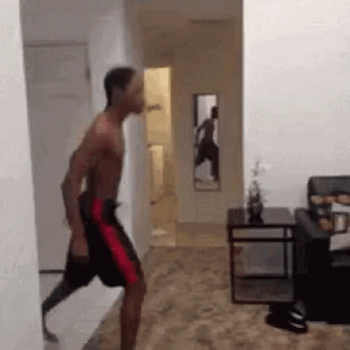 Man With Prosthetic Leg Walking Through Hallway GIF