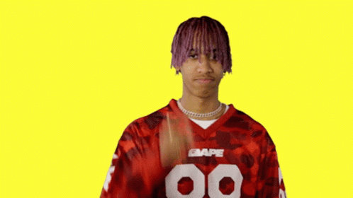 Man With Purple Hair Giving Peace Sign in Red BAPE Jersey