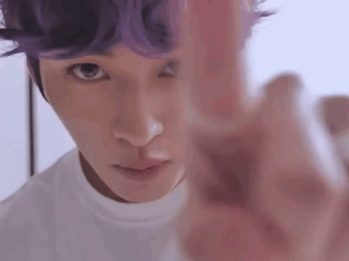 Man With Purple Hair Pointing At Camera
