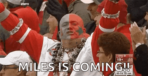 Man With Red And White Face Paint Says Miles Is Coming GIF