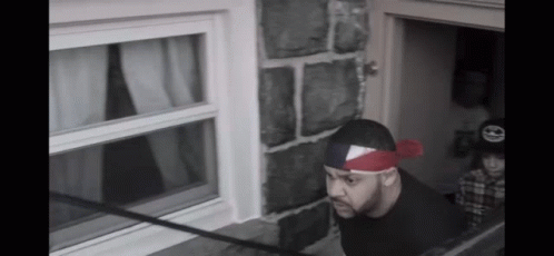 Man With Red Bandana Looking Out Window