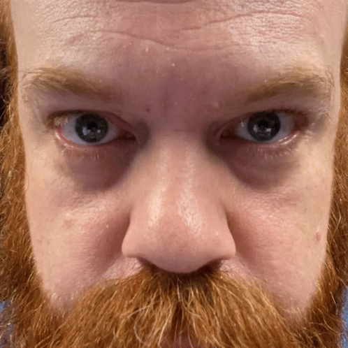 Man With Red Beard and Blue Eyes Looking at Camera