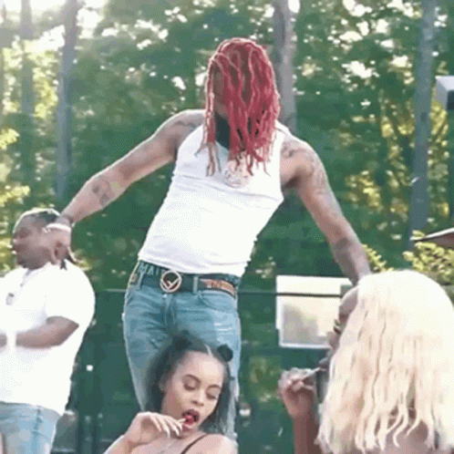 Man With Red Dreadlocks Standing on Woman's Lap