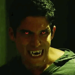 Man With Red Eyes and Vampire Teeth Smiling