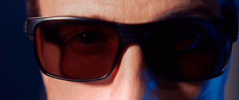 Man With Red Eyes Removing Eyeglasses GIF