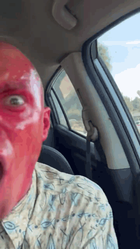 Man with Red Face Paint Sitting in Car