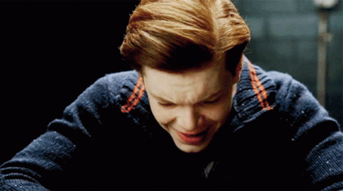 Man With Red Hair and Blue Sweater Smiles