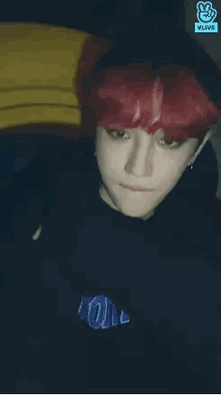 Man with Red Hair in Front of Vlive Screen