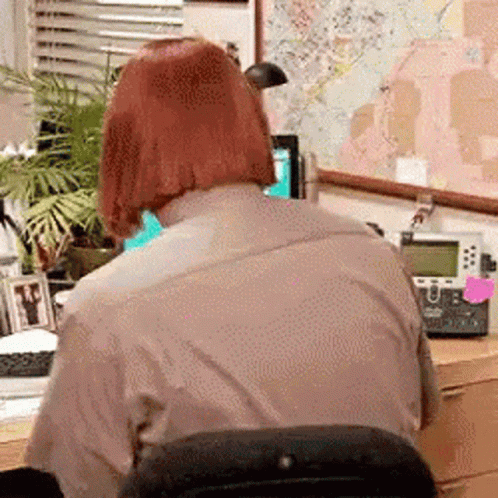 Man with Red Hair Sitting at Desk
