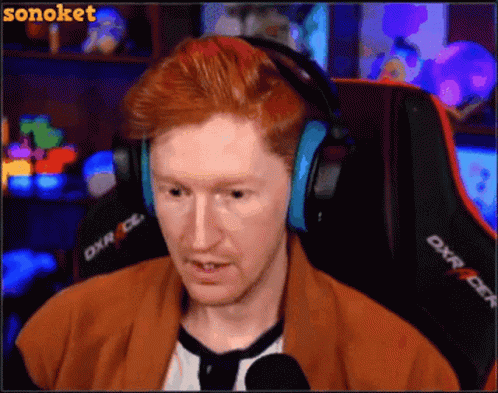 Man with Red Hair Wearing Headphones Sitting in Chair DXR