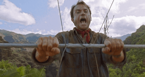 Man With Red Scarf Biting Wire GIF
