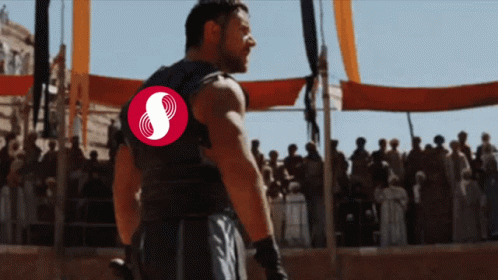 Man With Red Symbol on Back Before Crowd