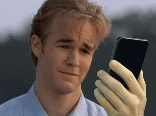 Man With Sad Look Holding Cellphone GIF