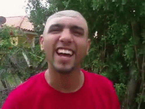 Man With Shaved Head And Beard Smiling In Red Shirt GIF