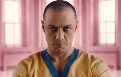 Man with Shaved Head in Yellow and Blue Shirt