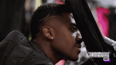 Man With Shaved Head Looking Out Car Window