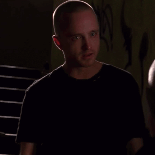 Man With Shaved Head Talking To Another Man GIF