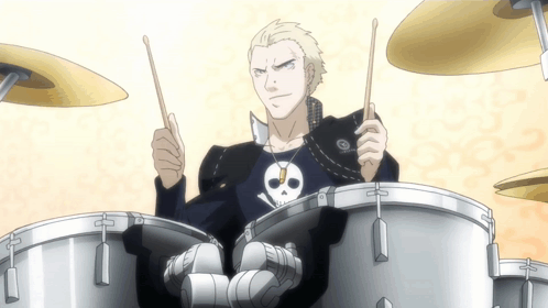 Man With Skull and Crossbones Shirt Playing Drums
