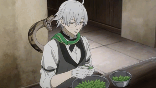 Man With Snake Around Neck Preparing Food